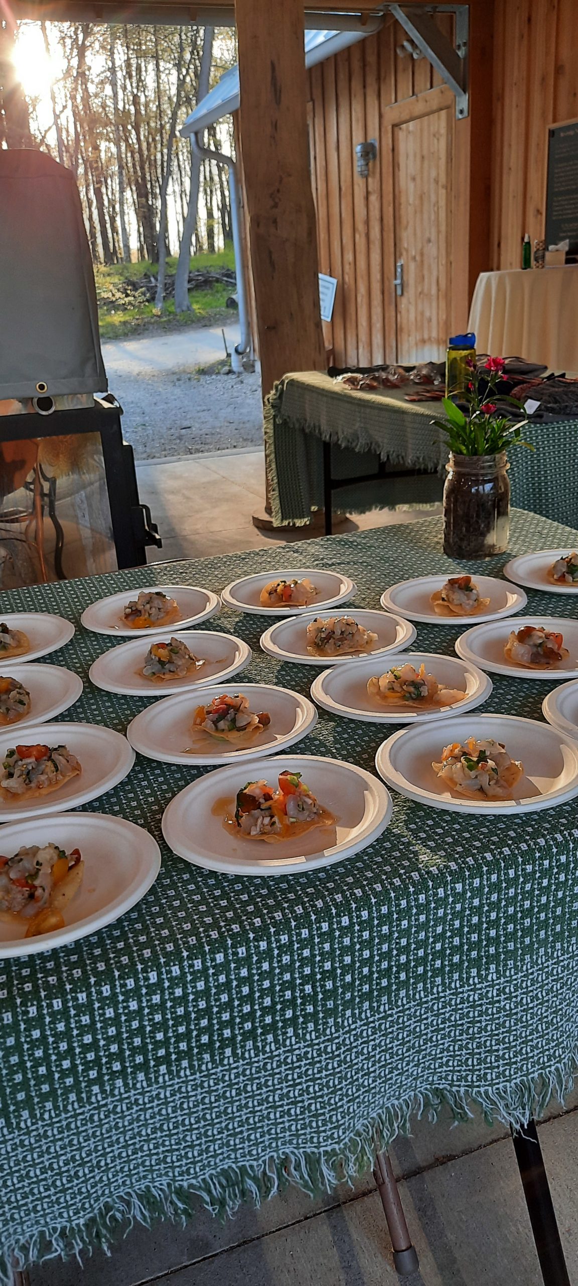 a table of plated dishes outside the sugarbush house for small plates big brews