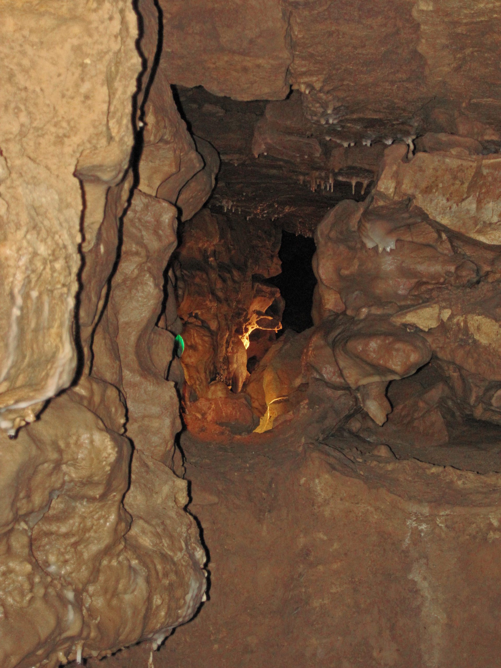 underground cave passageway lit up by a lamp
