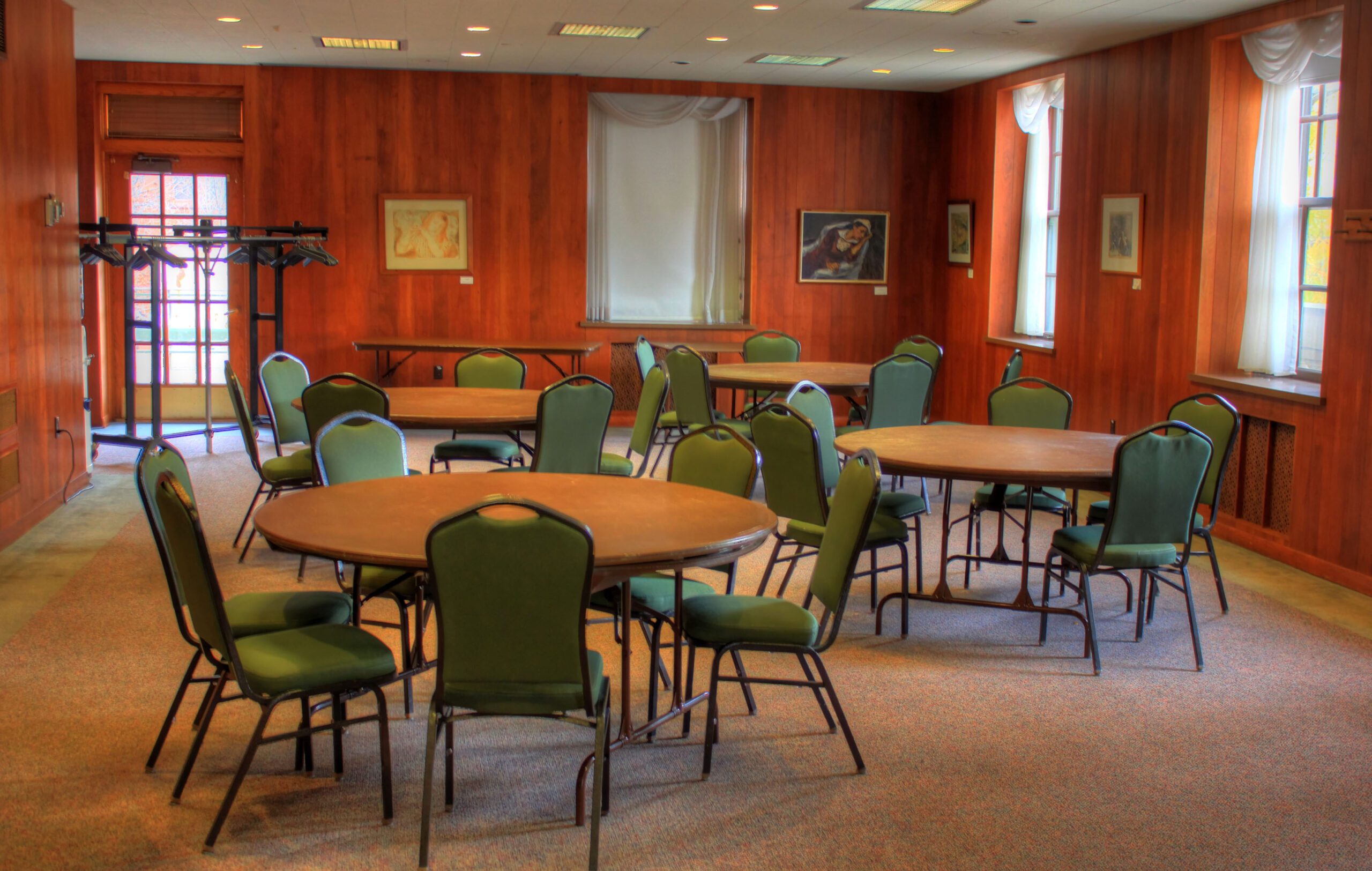 4 large rounds tables with chairs in a room