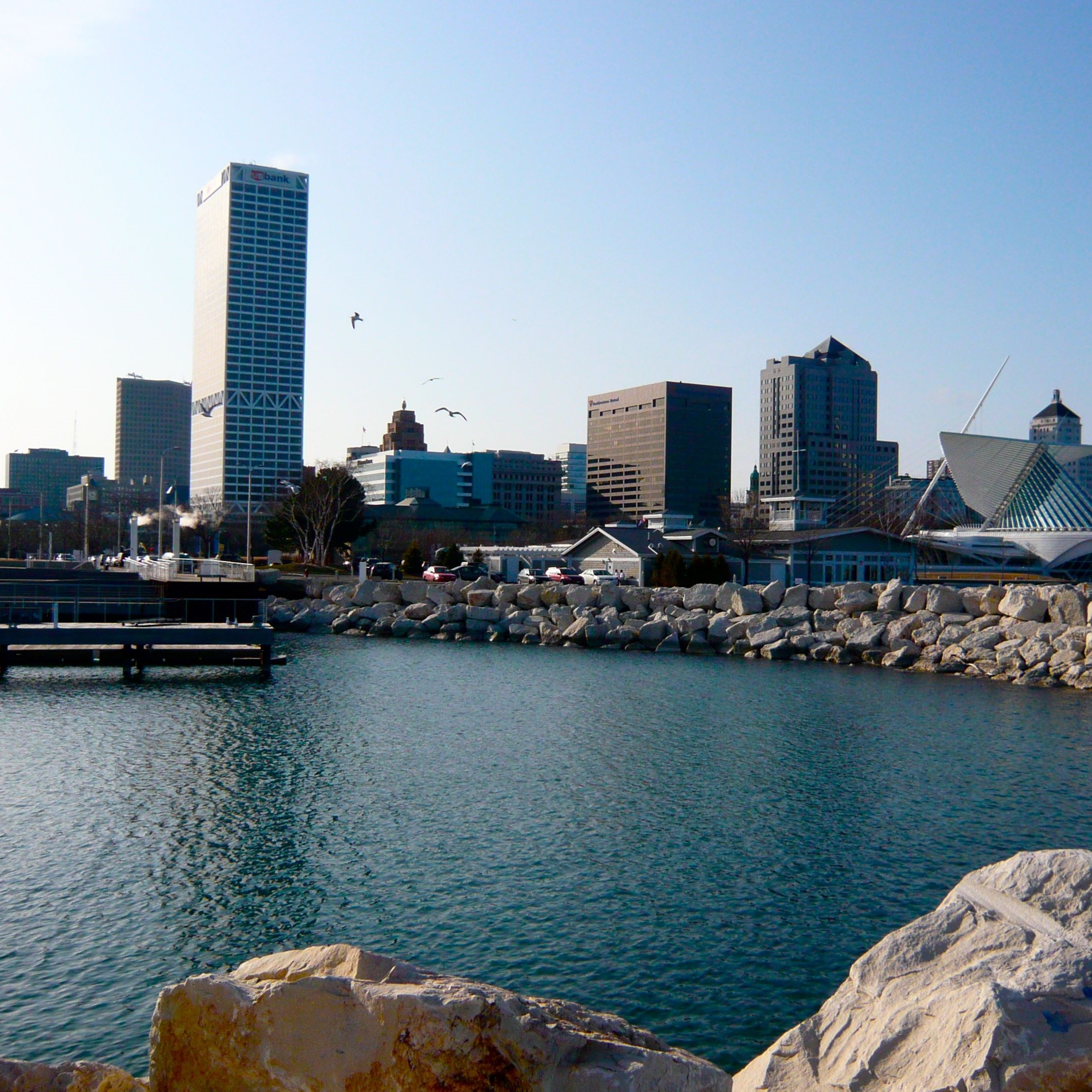 rocky shoreline of Lake Michigan in the downtown city of Milwaukee with skyscrapers in the background